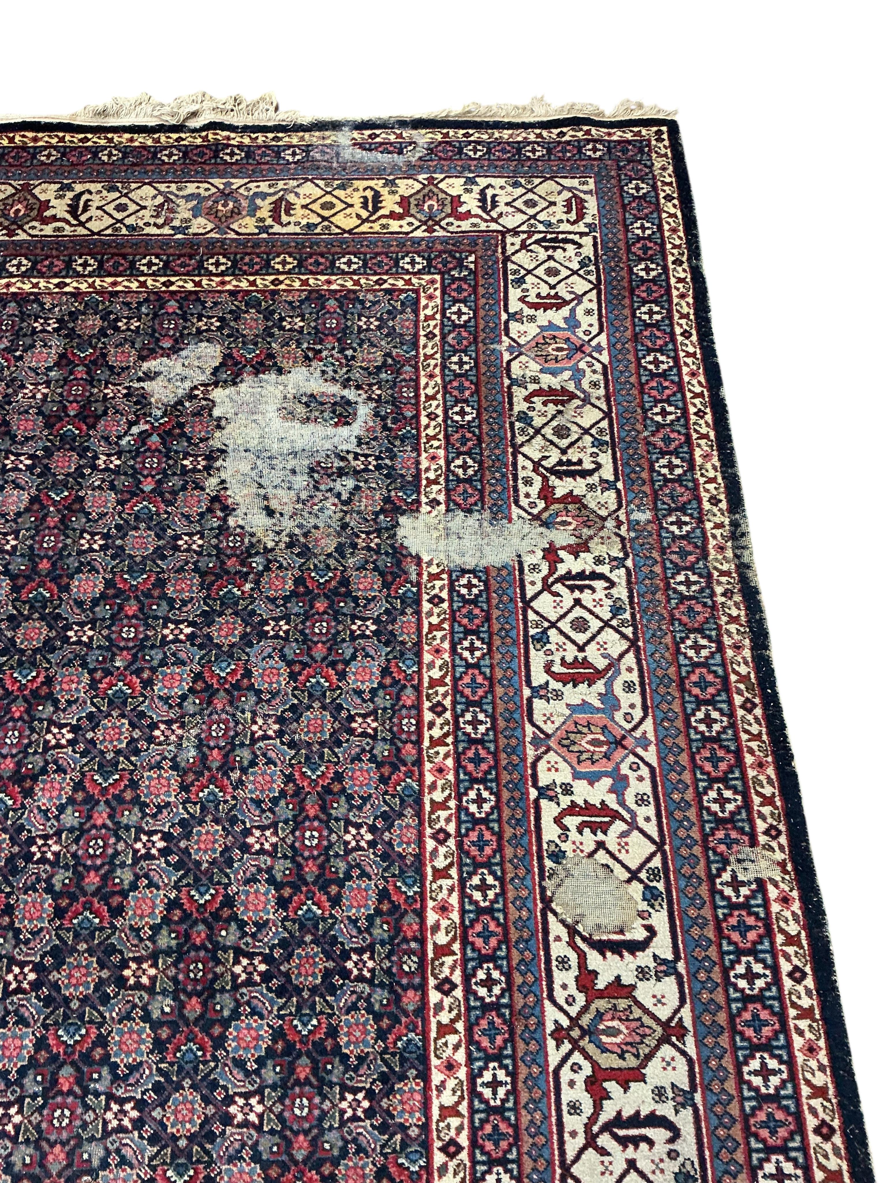 An early 20th century Tabriz blue ground floral carpet, moth damage, 440 x 340cm